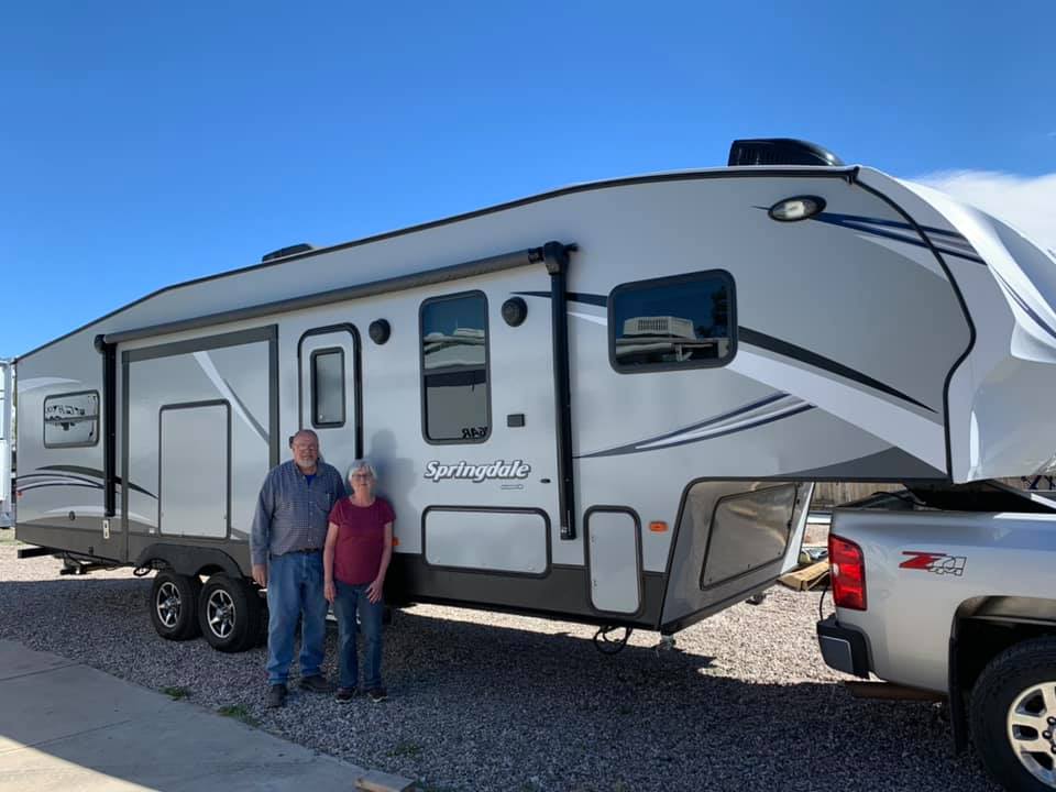 Nelson RV used 5th wheel on pickup truck with happy customers in Tucson Arizona